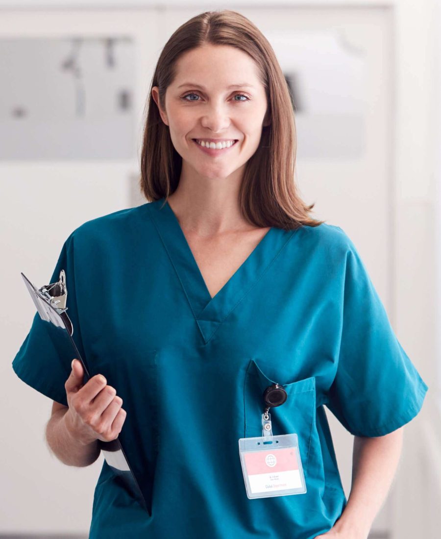 portrait-of-smiling-female-doctor-wearing-scrubs-s-9FCN8AY